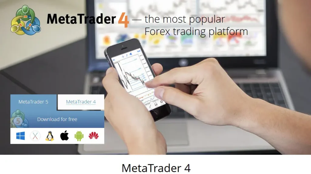 A trader using the mobile version of mt4 with charts open next to a laptop.
